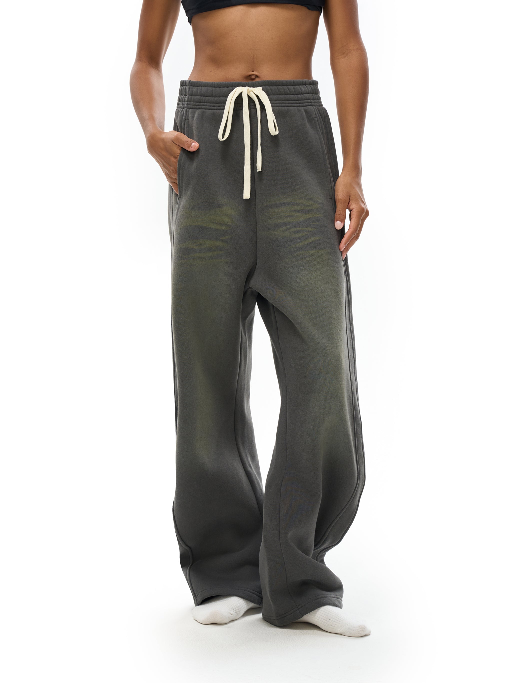 Wide-leg faded black fleece sweatpants with cream drawstring on model