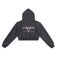Black cropped hoodie with VILLAIN Dominion Collection text on back, streetwear style