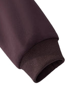 Close-up of brown heavyweight streetwear hoodie sleeve and ribbed cuff