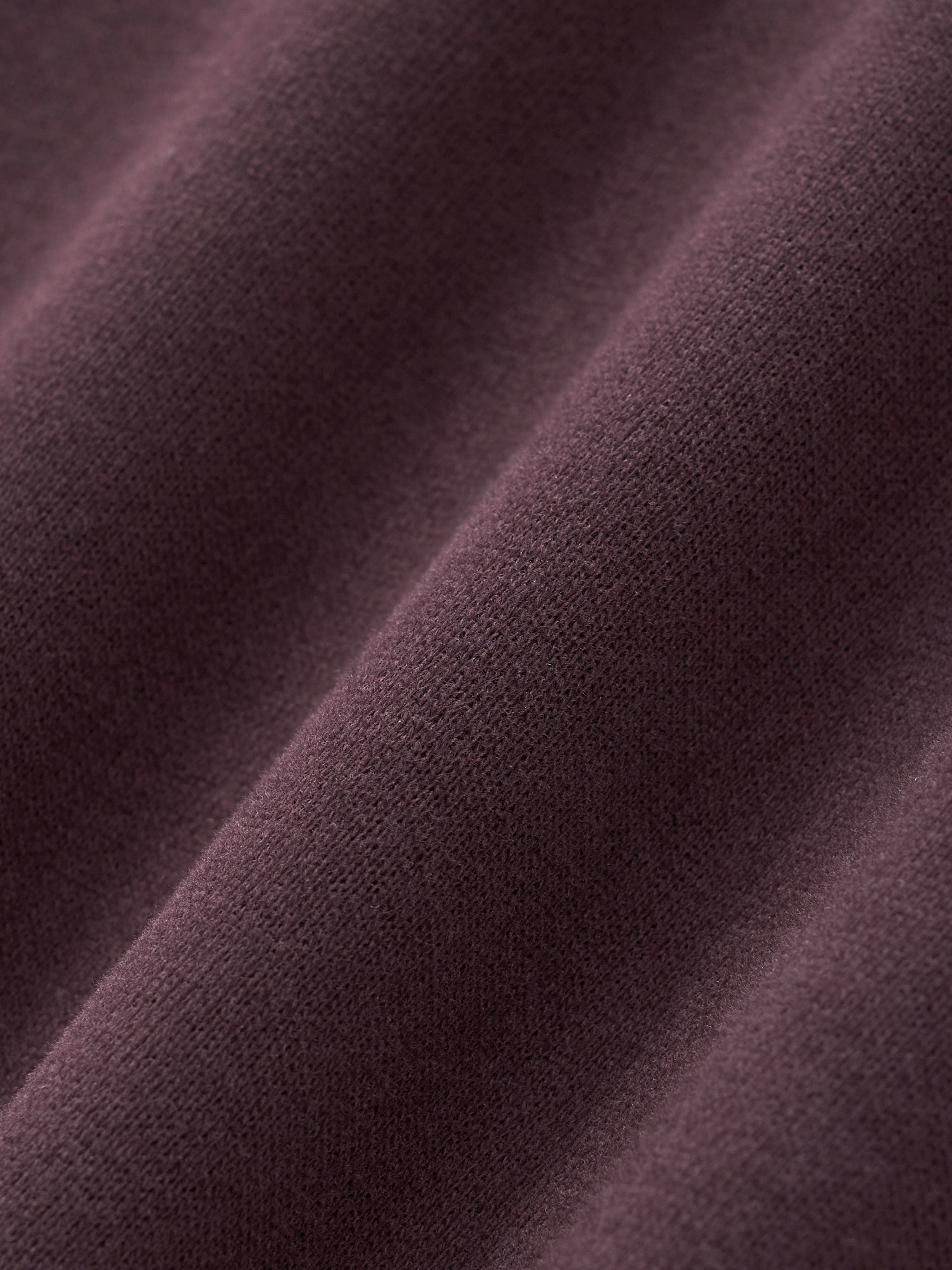 Close-up of heavyweight purple streetwear fabric with soft texture and visible weave