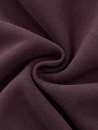 Close-up of heavyweight streetwear fabric in a dark brown, soft knit texture.