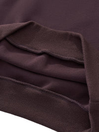 Close-up of heavyweight cropped hoodie hem in dark purple with ribbed trim