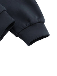 Close-up of black jogger sweatpants cuffs with ribbed hem on white background.