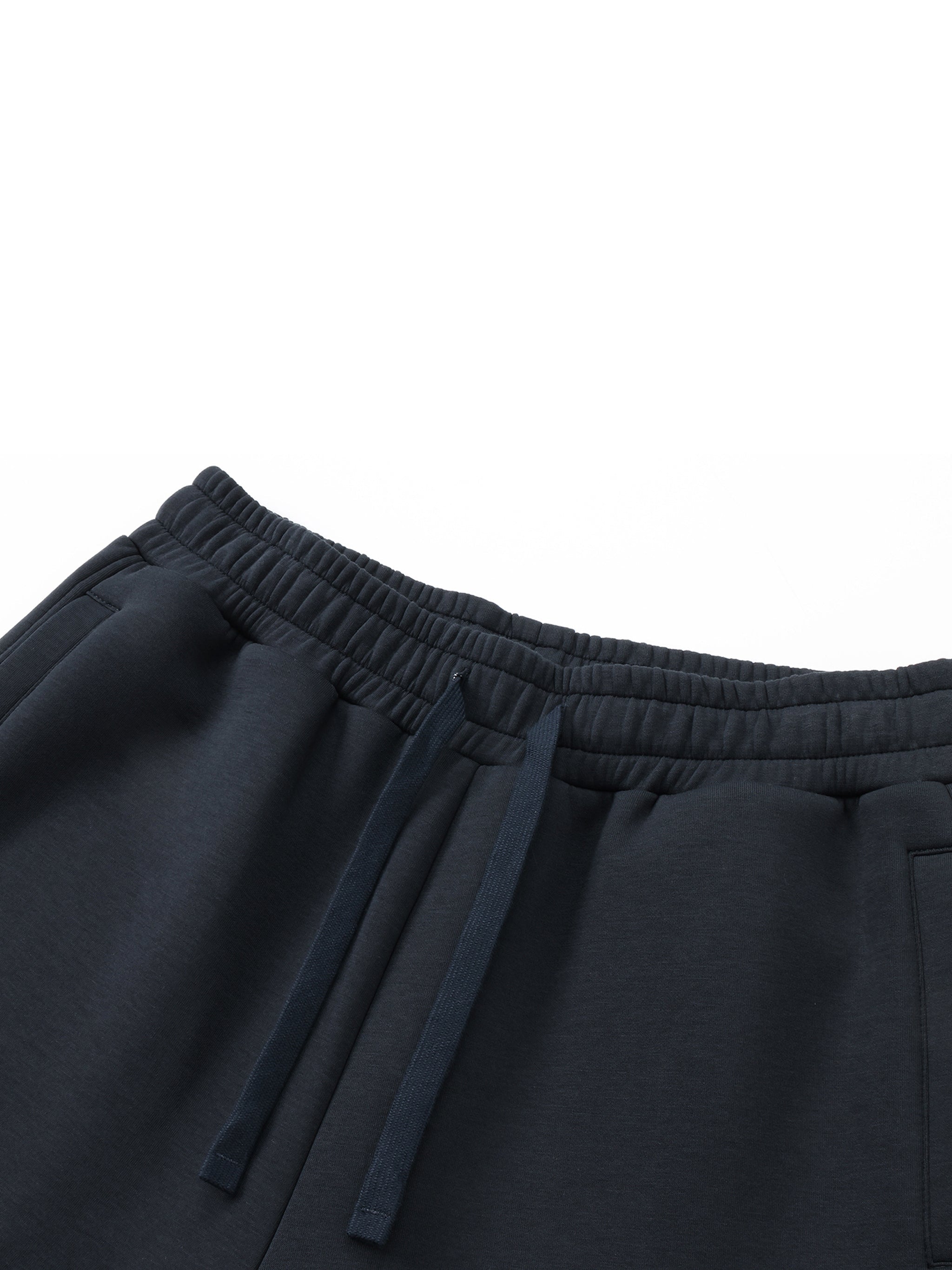 Black heavyweight drawstring sweatpants with elastic waistband and side pockets on white background