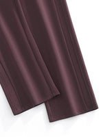 Close-up of straight leg, dark brown sweatpants with seam details on white background.