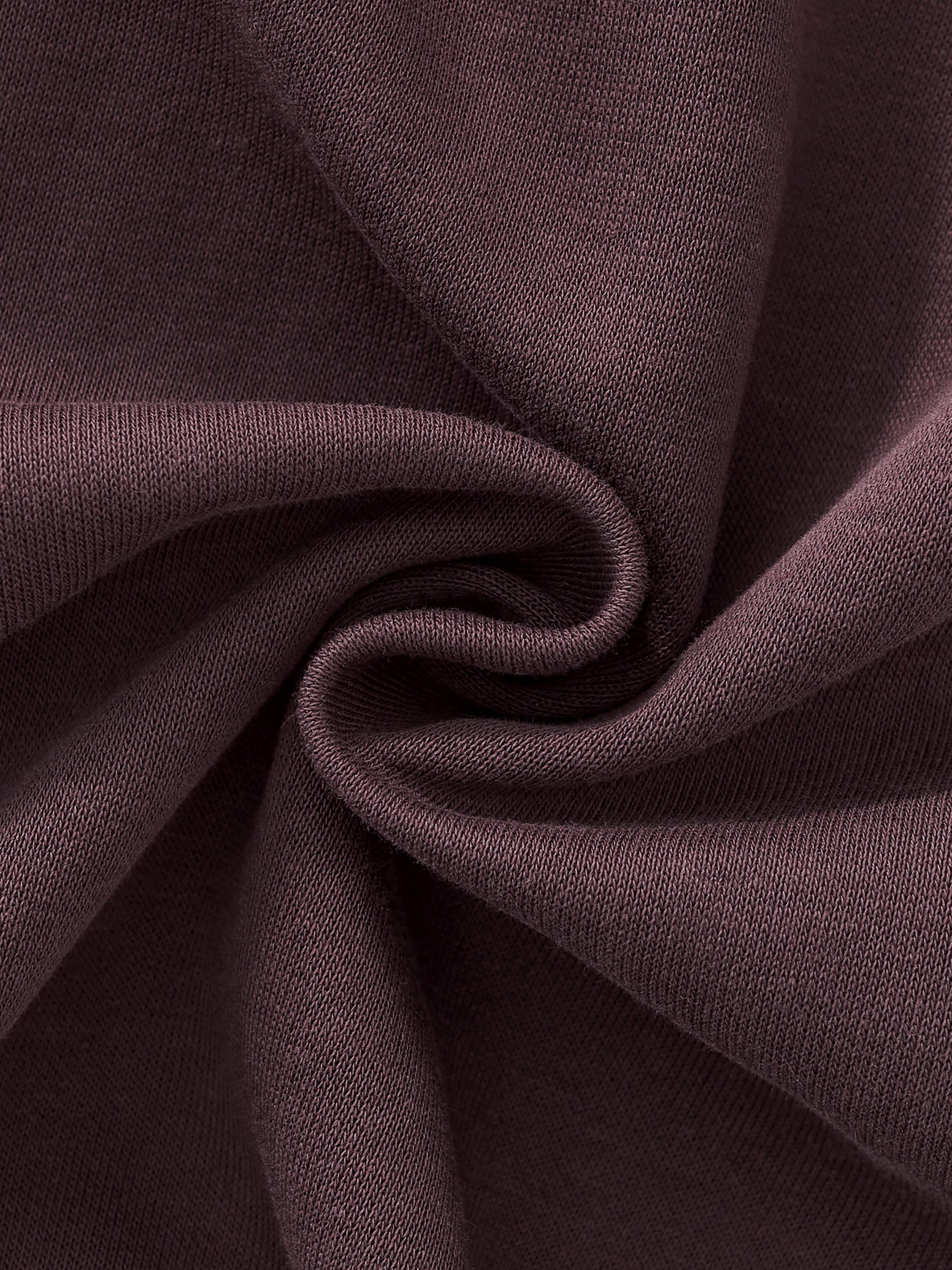 Close-up of heavyweight brown sweatpants fabric with soft texture and knit weave detail