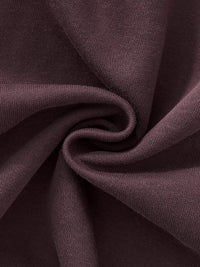 Close-up of heavyweight brown sweatpants fabric with soft texture and knit weave detail