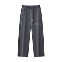 Dark grey straight leg sweatpants with drawstring, pocket details, and 'VILLAIN' text print