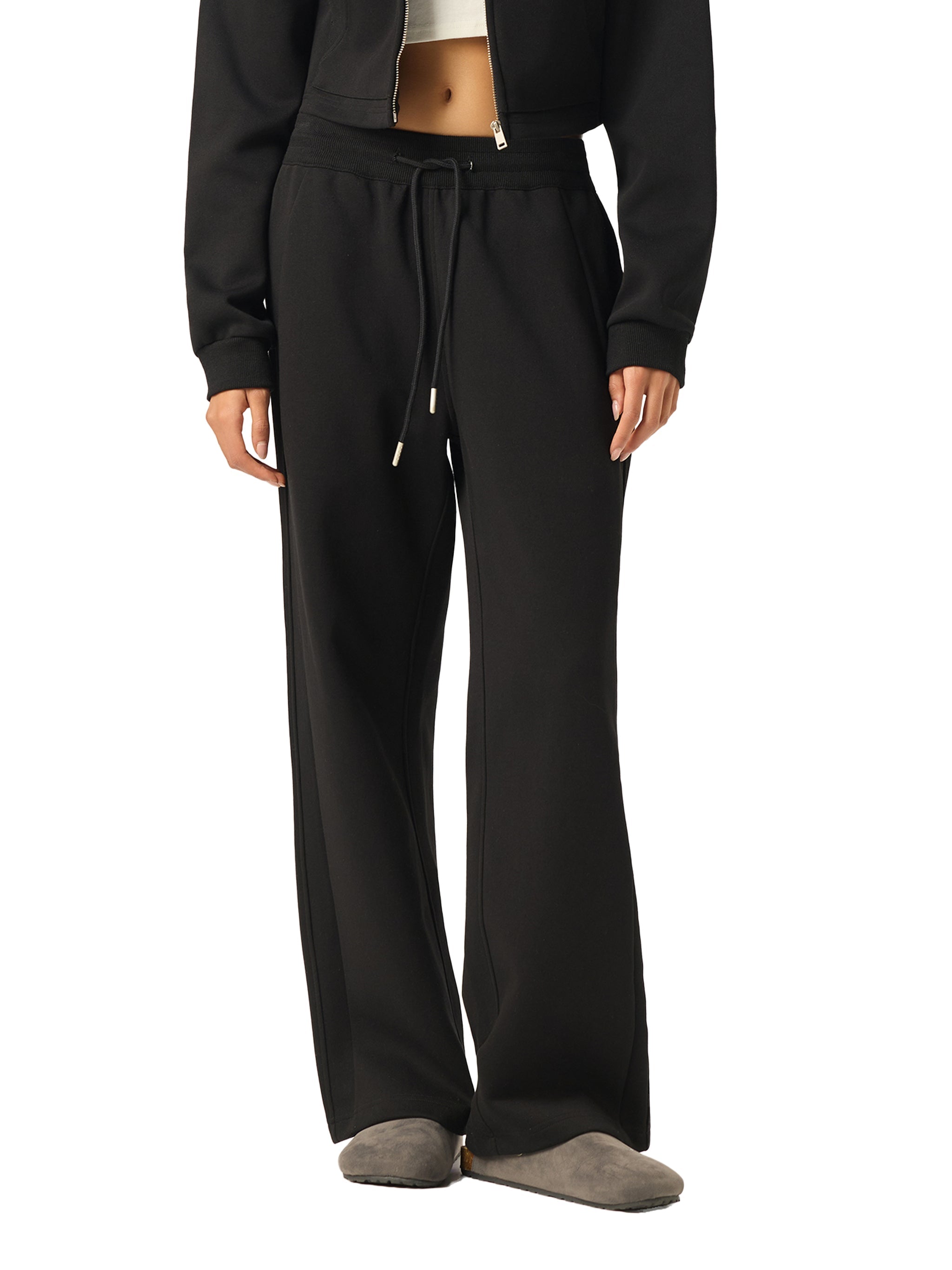 Black straight-leg sweatpants with drawstring waist, modeled on a white background
