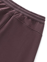 Close-up of dark brown drawstring sweatpants with straight leg and ribbed waistband