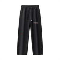 Black straight leg sweatpants with drawstring waist, 'VILLAIN' logo and red accent