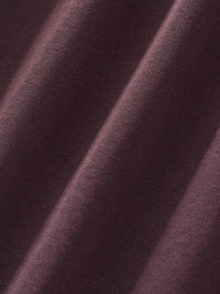 Close-up of heavyweight brown sweatpants fabric with visible texture and soft folds