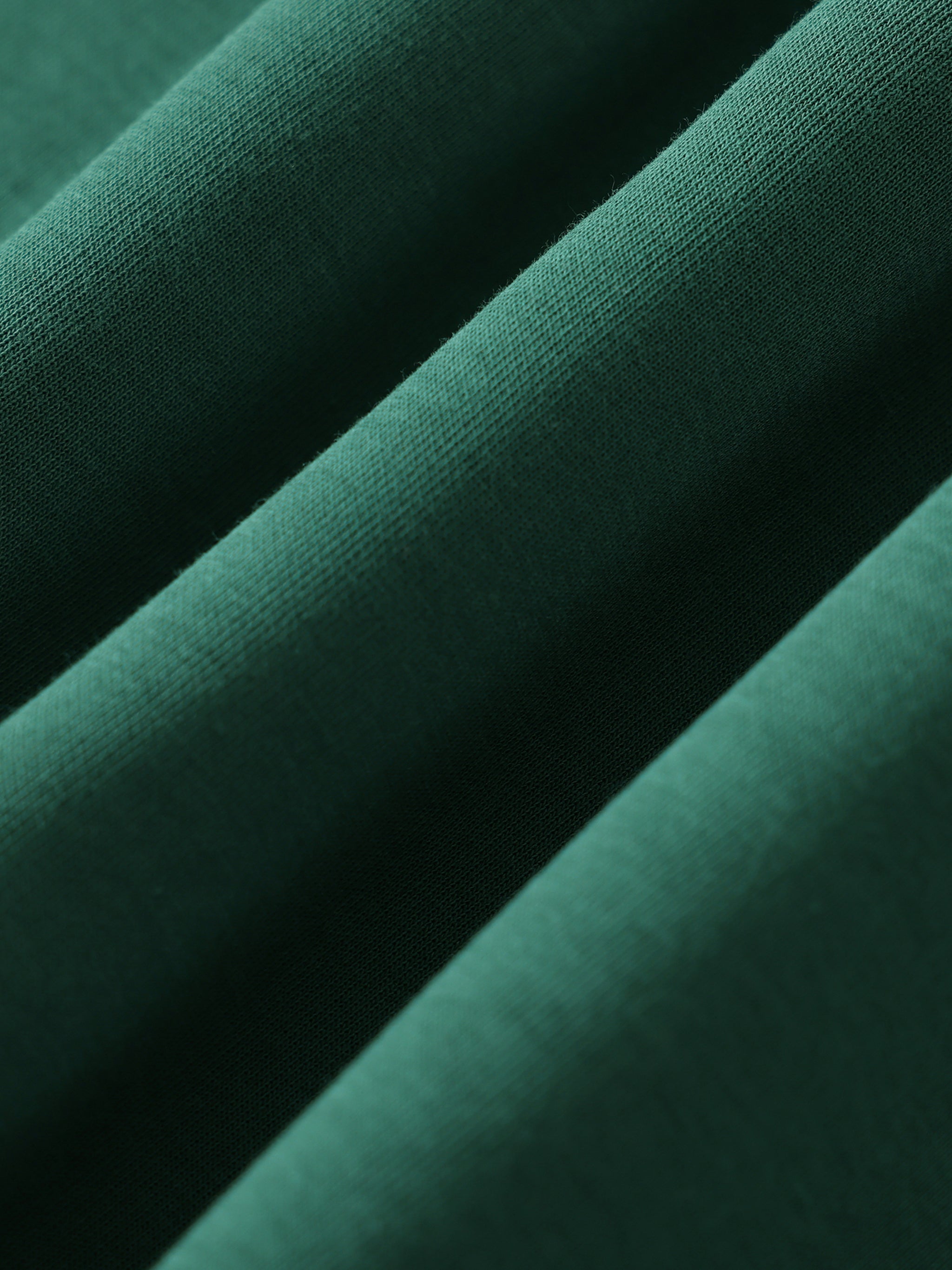 Close-up of heavyweight dark green crewneck sweatshirt fabric texture