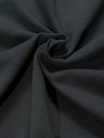 Close-up of heavyweight black knitted cotton fabric with textured ribbing