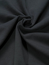 Close-up of heavyweight black knitted cotton fabric with textured ribbing