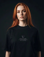 Woman in black heavyweight knitted round neck t-shirt with 'VILLAIN' text on front