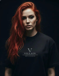Woman with long red hair wearing heavyweight black t-shirt with 'Villain' graphic text