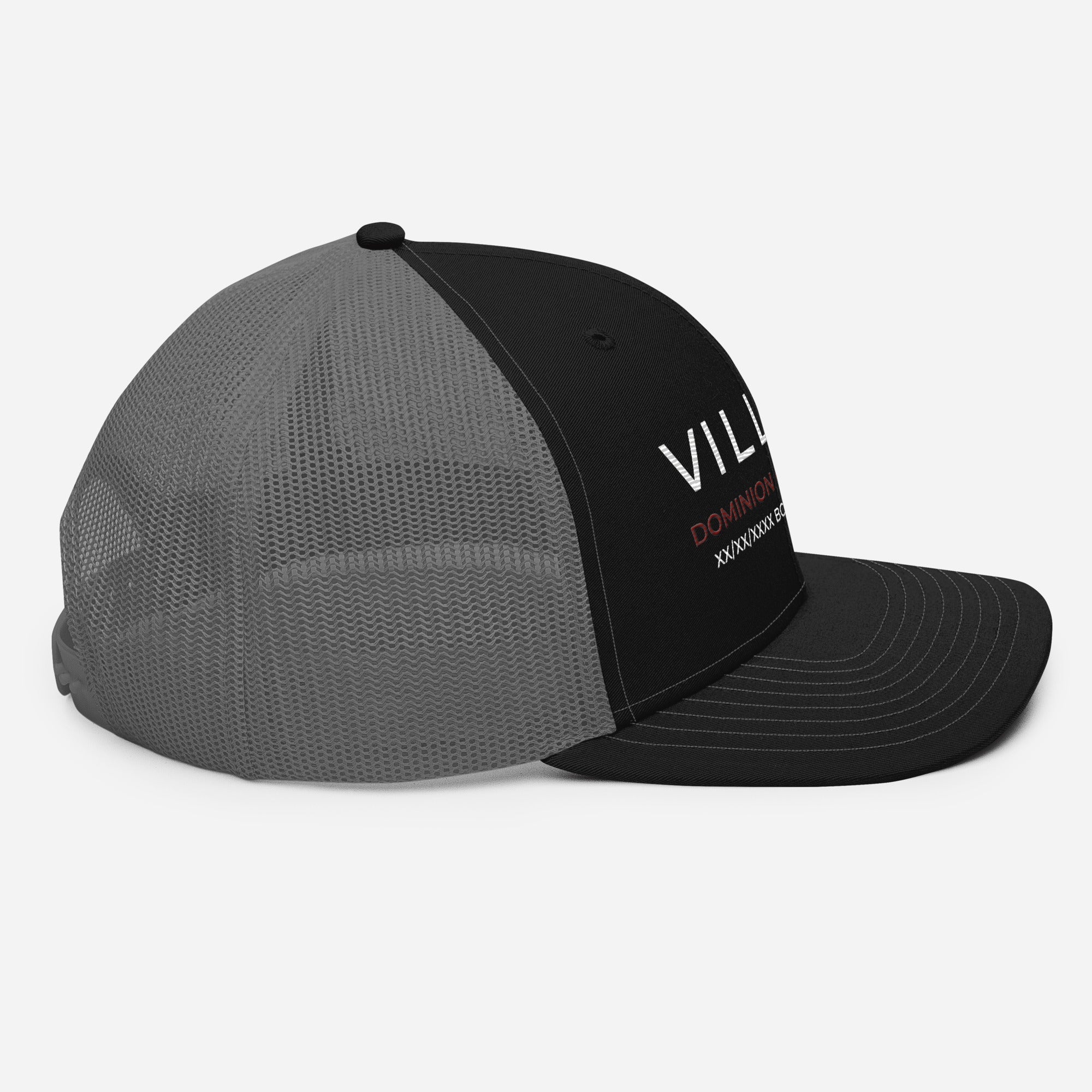 Black and grey mesh trucker cap with 'VILLAIN DOMINION' text on front panel, side view