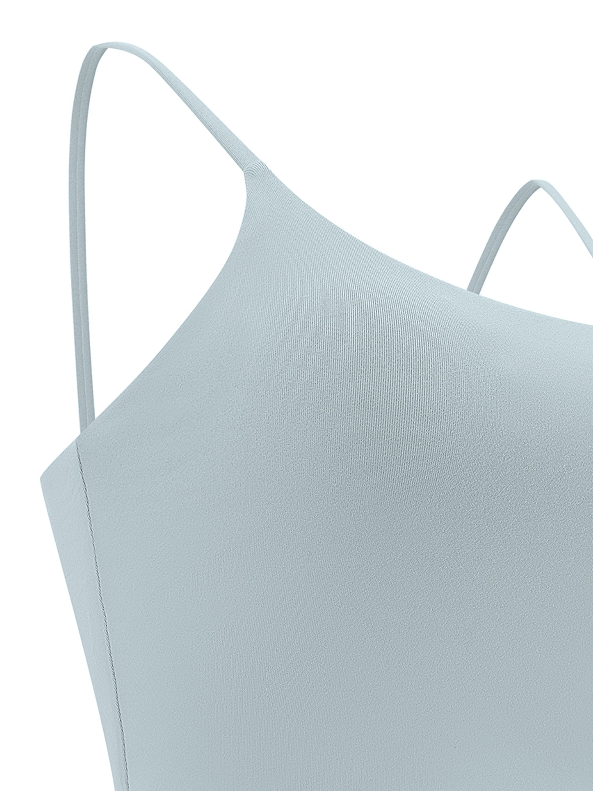 Light blue spaghetti strap yoga sports bra with minimalist design, close-up view.