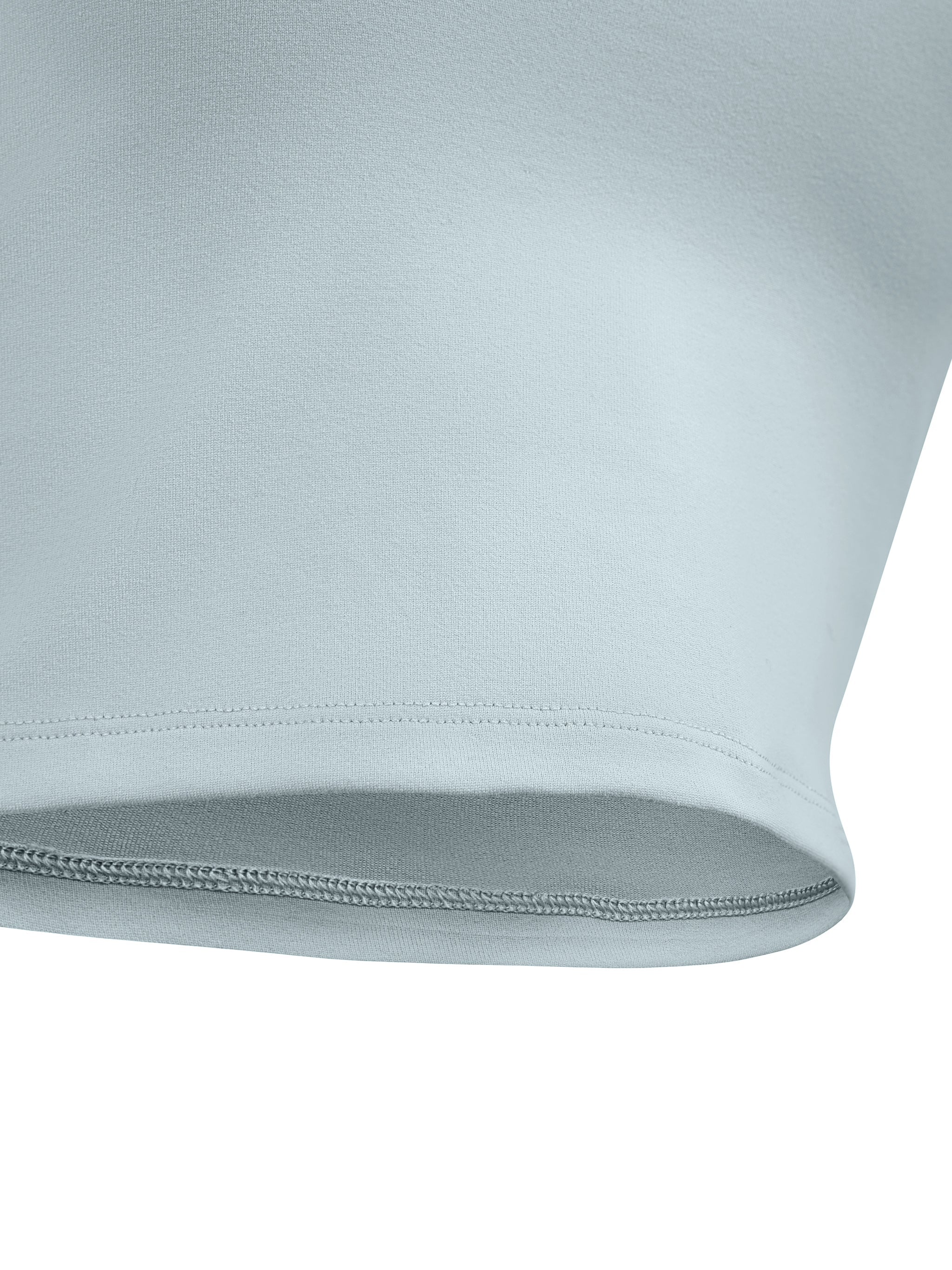Close-up of light blue seamless yoga sports bra hem detail