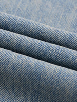 Light blue raw hem denim fabric with visible texture and weave detail
