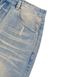 Light wash raw hem denim jeans with sun-fade effect and distressed pocket detail
