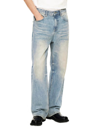 Wide-leg sun-faded light blue raw hem denim jeans with relaxed fit, styled with black shoes