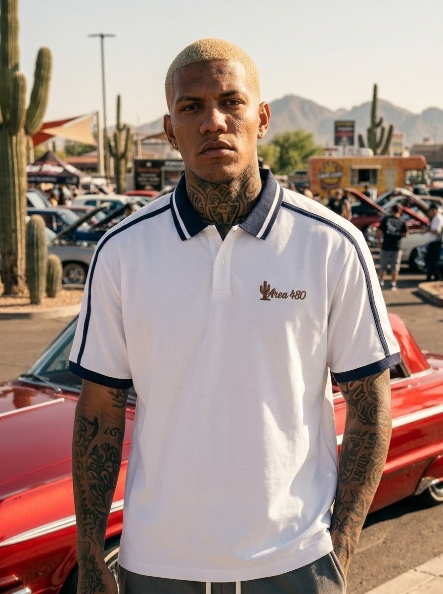 Man in white unisex contrast piping polo shirt with Area 480 logo at outdoor car show