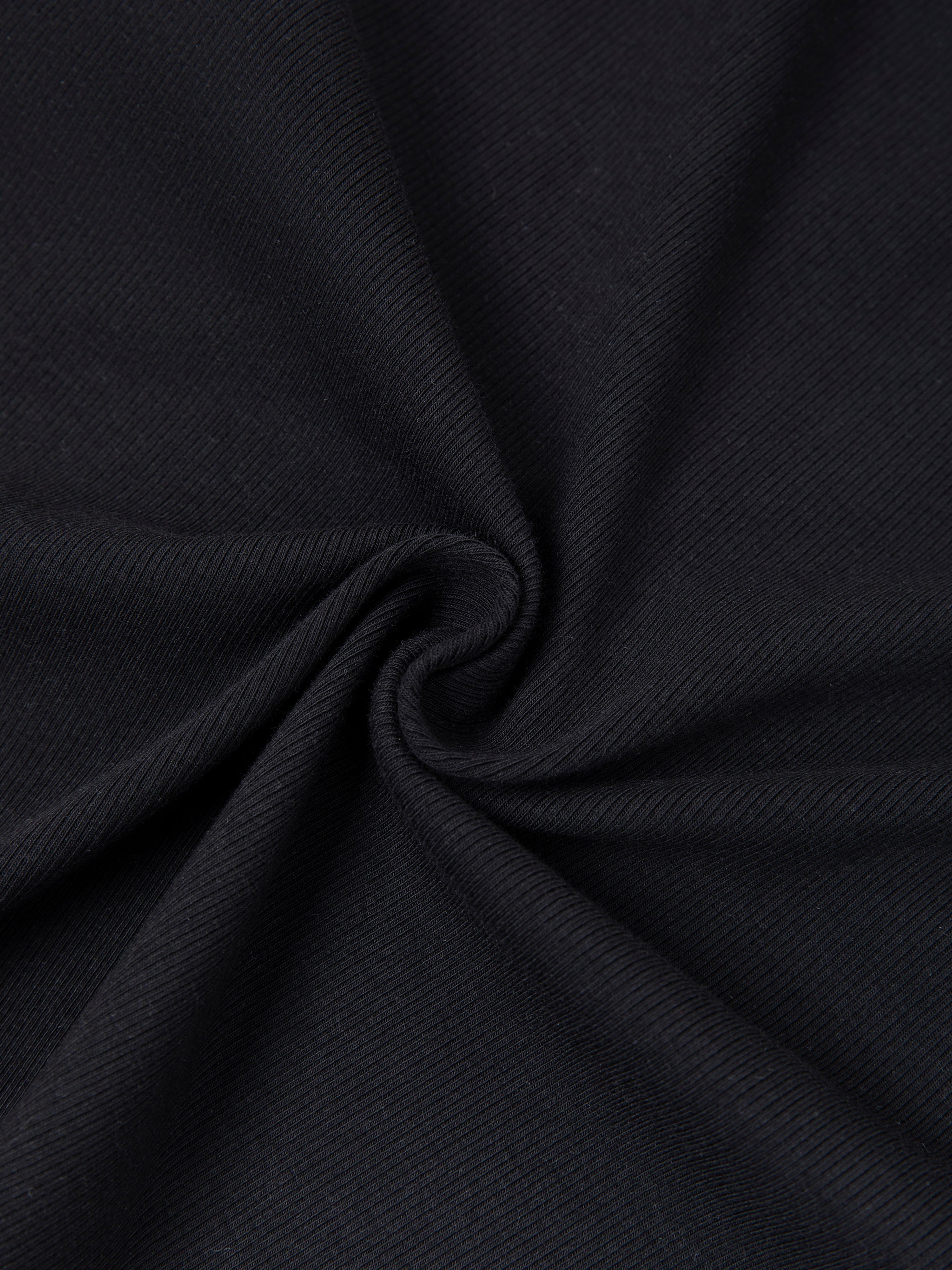 Close-up of black ribbed heavyweight fabric with subtle textured pattern.