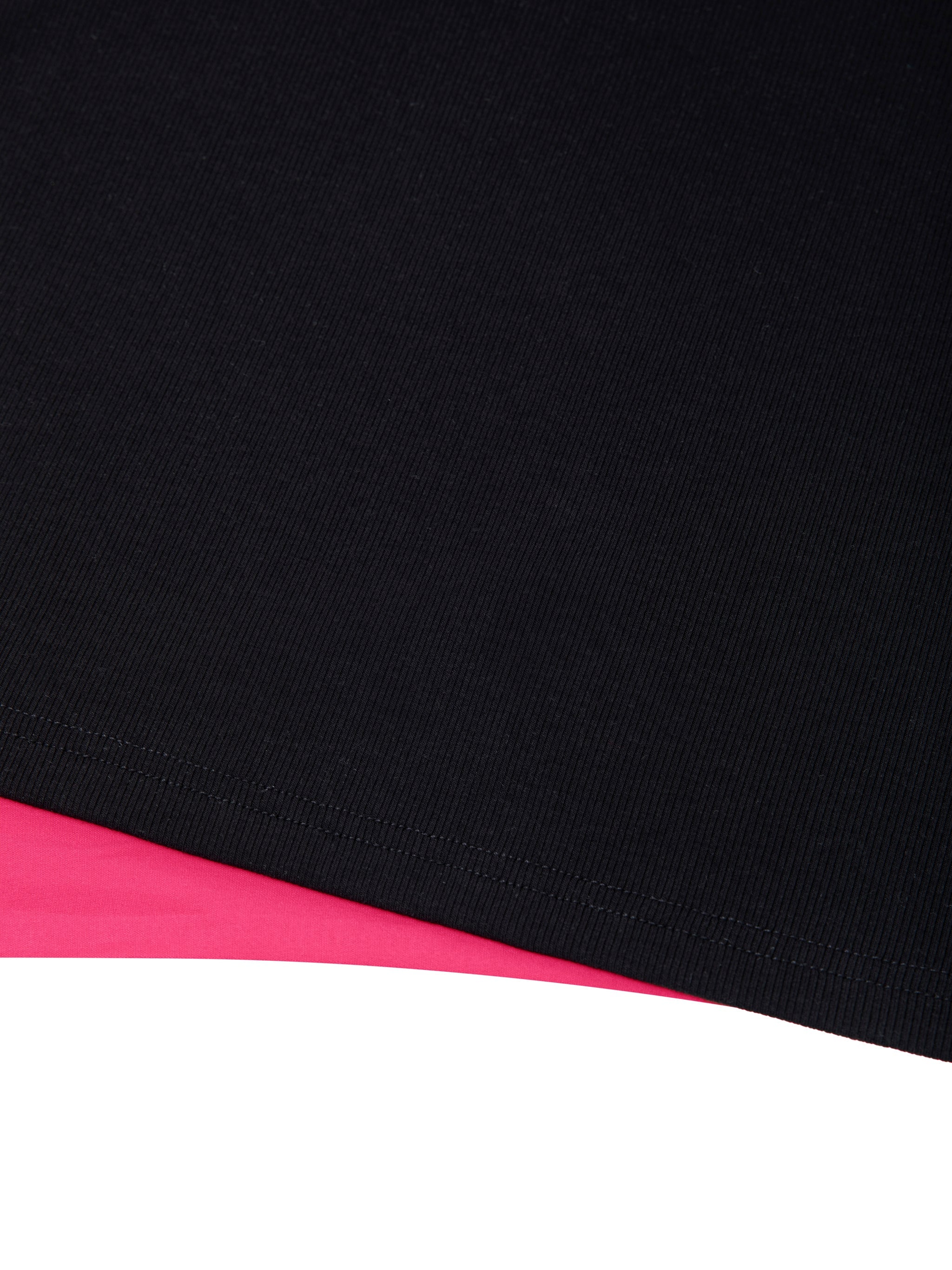 Close-up of black ribbed slim-fit boatneck t-shirt hem on pink background