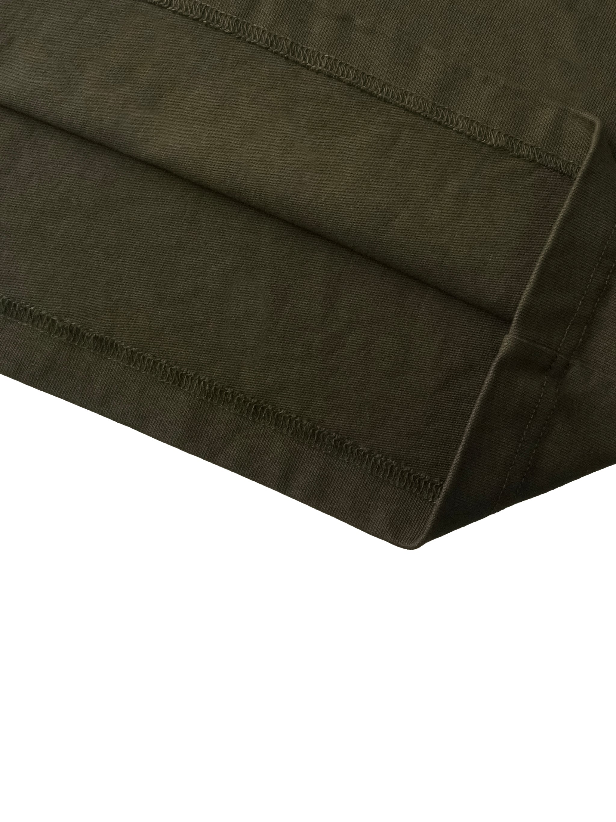 Close-up of olive green boxy t-shirt hem with sun-fade and distressed stitching