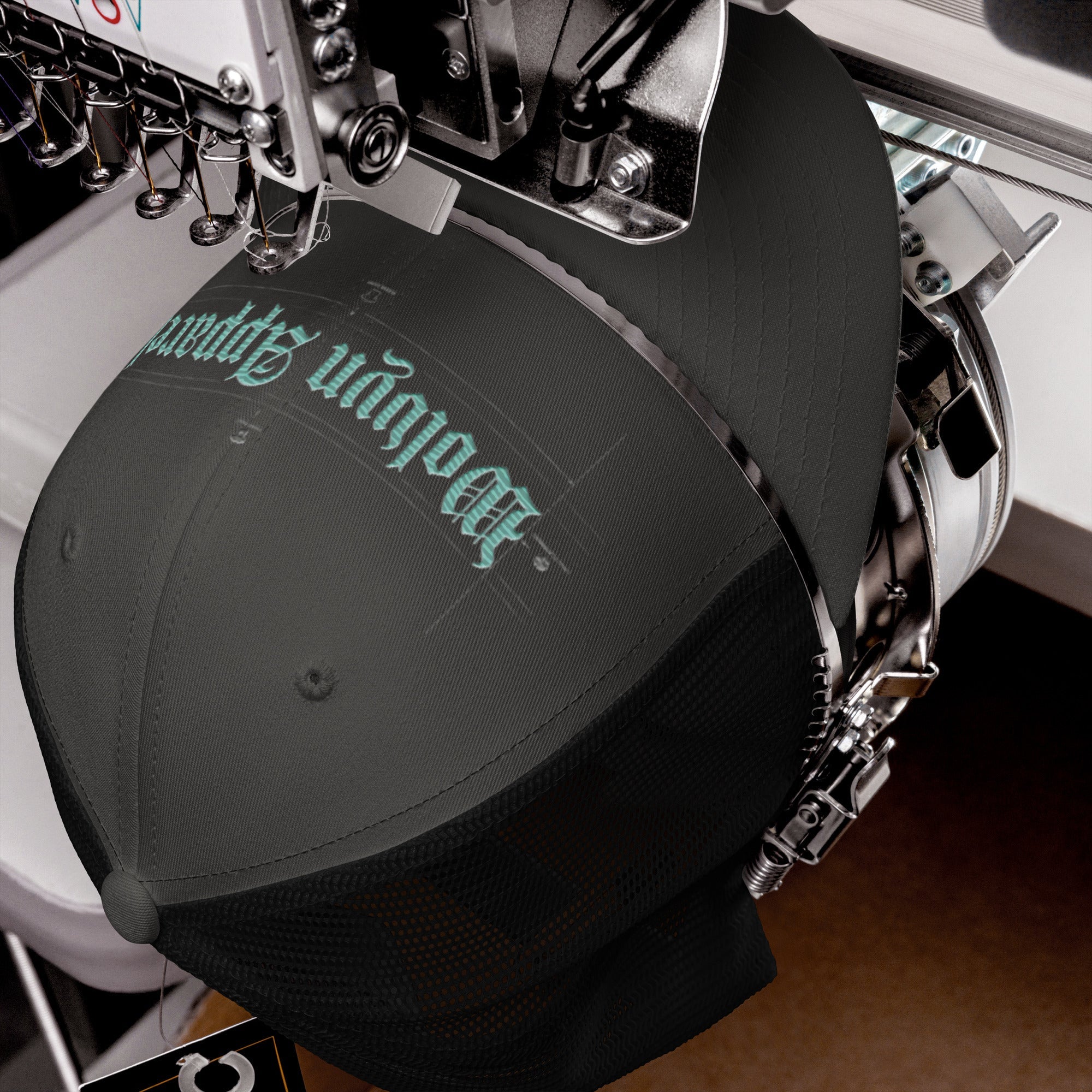 Black mid-profile trucker cap with embroidered gothic text on embroidery machine