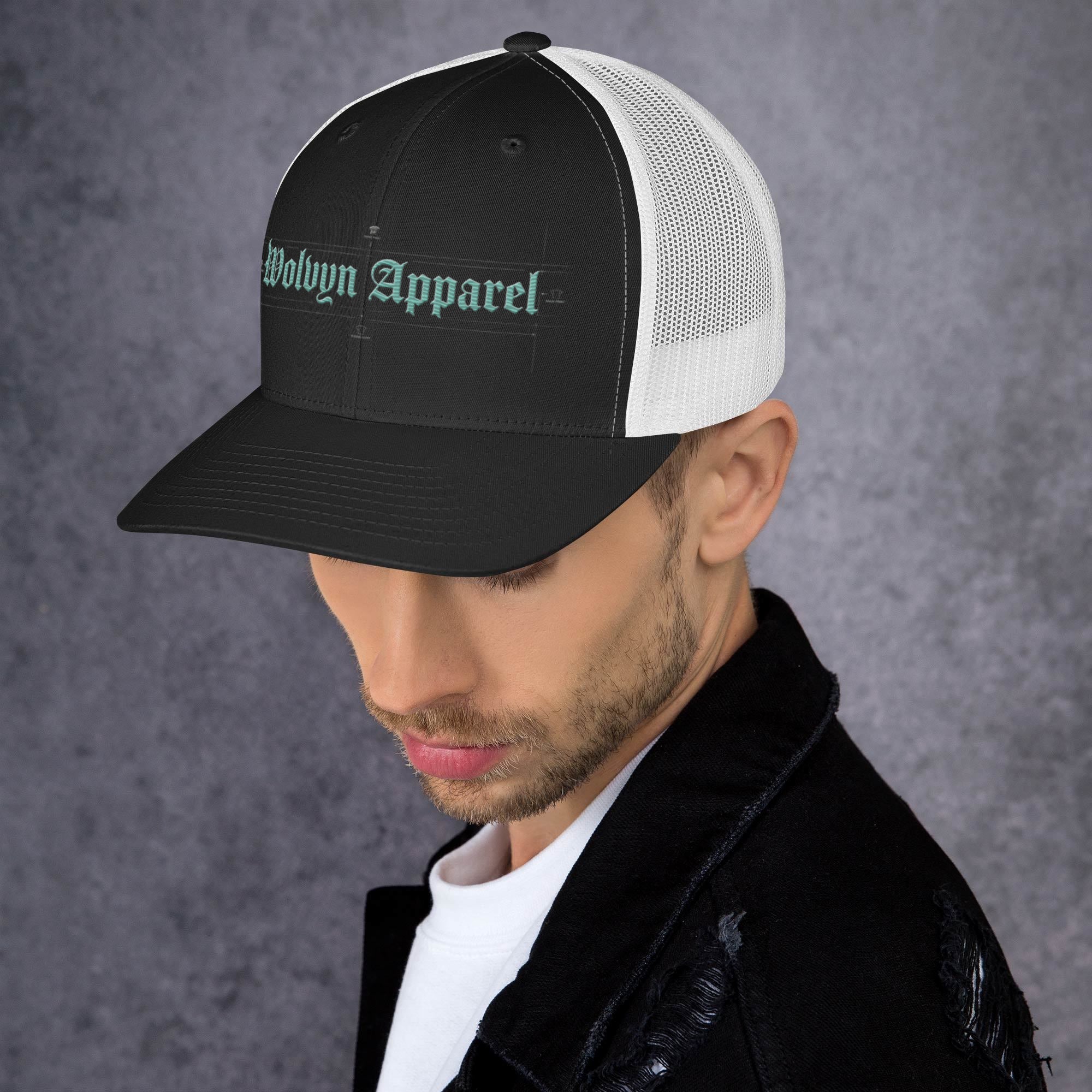 Black and white mid-profile trucker cap with embroidered script logo on a man