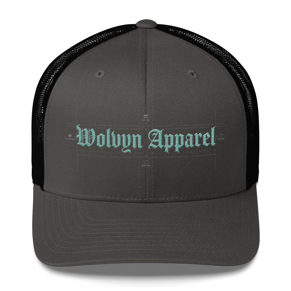 Gray and black mid-profile trucker cap with embroidered 'Wolvyn Apparel' text on front