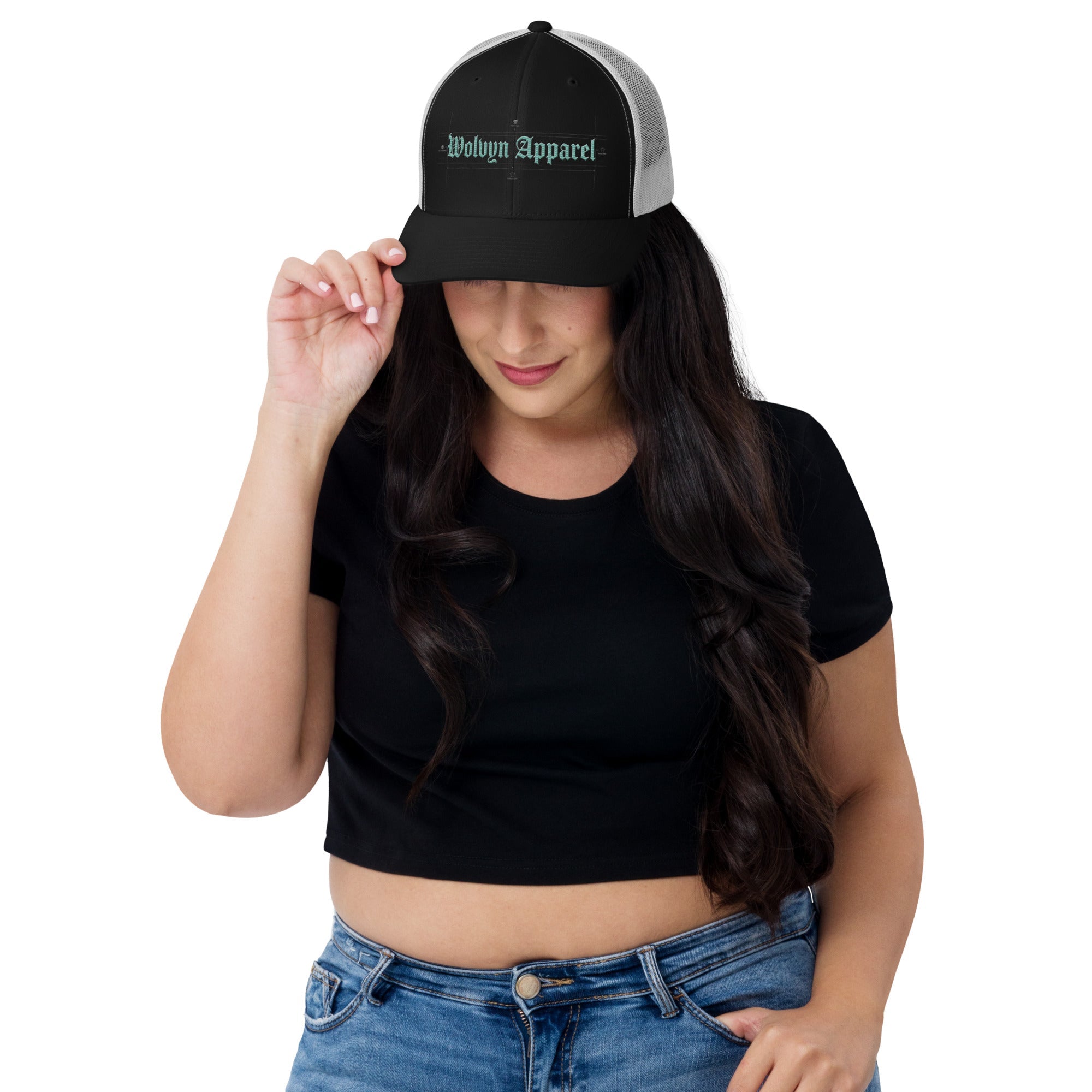 Woman wearing a black and white embroidered trucker cap and casual streetwear outfit