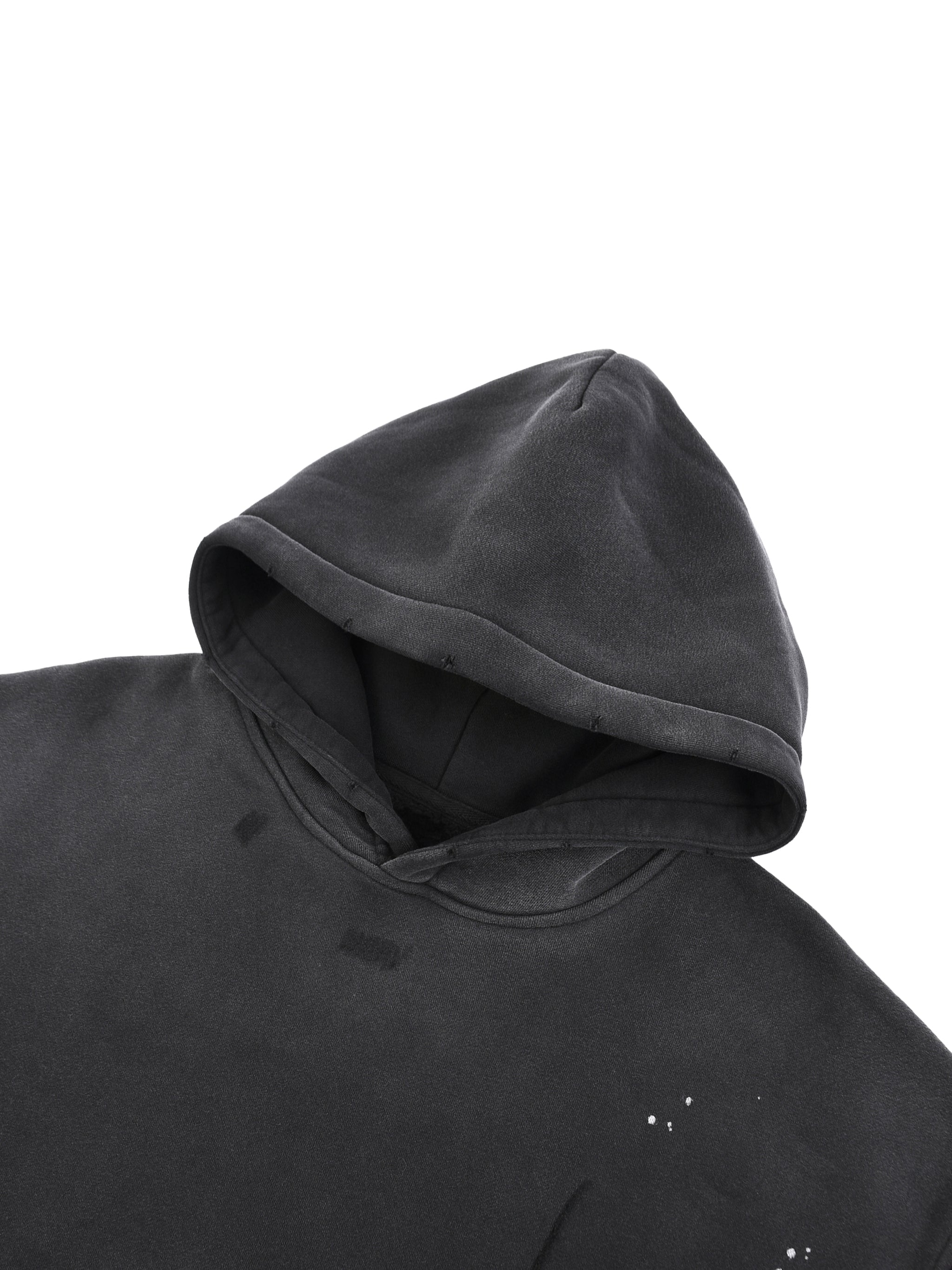 Washed black fleece hoodie with frayed edges and paint splatter distressed detail