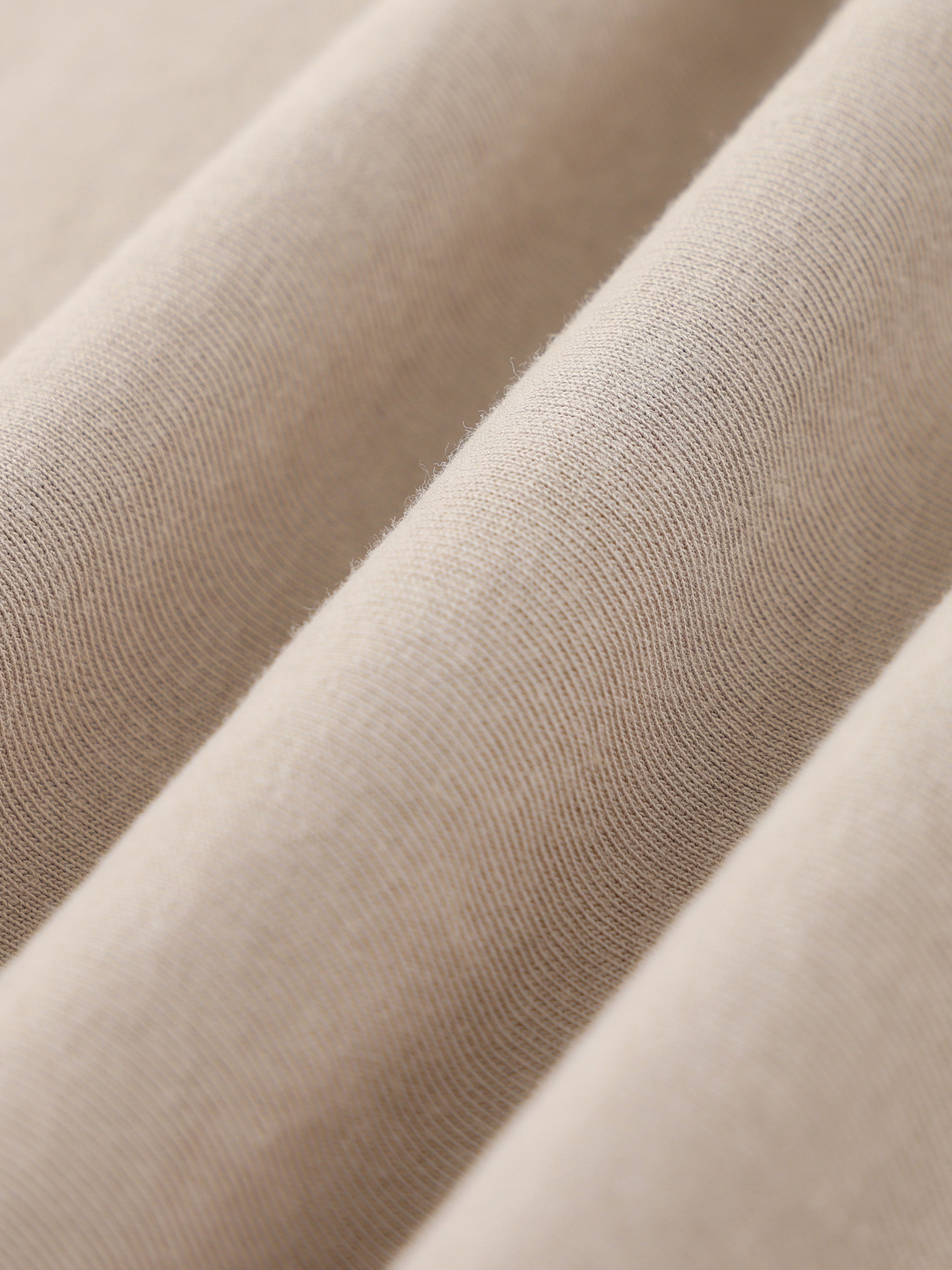 Close-up of beige heavyweight cotton fabric with visible texture and soft finish