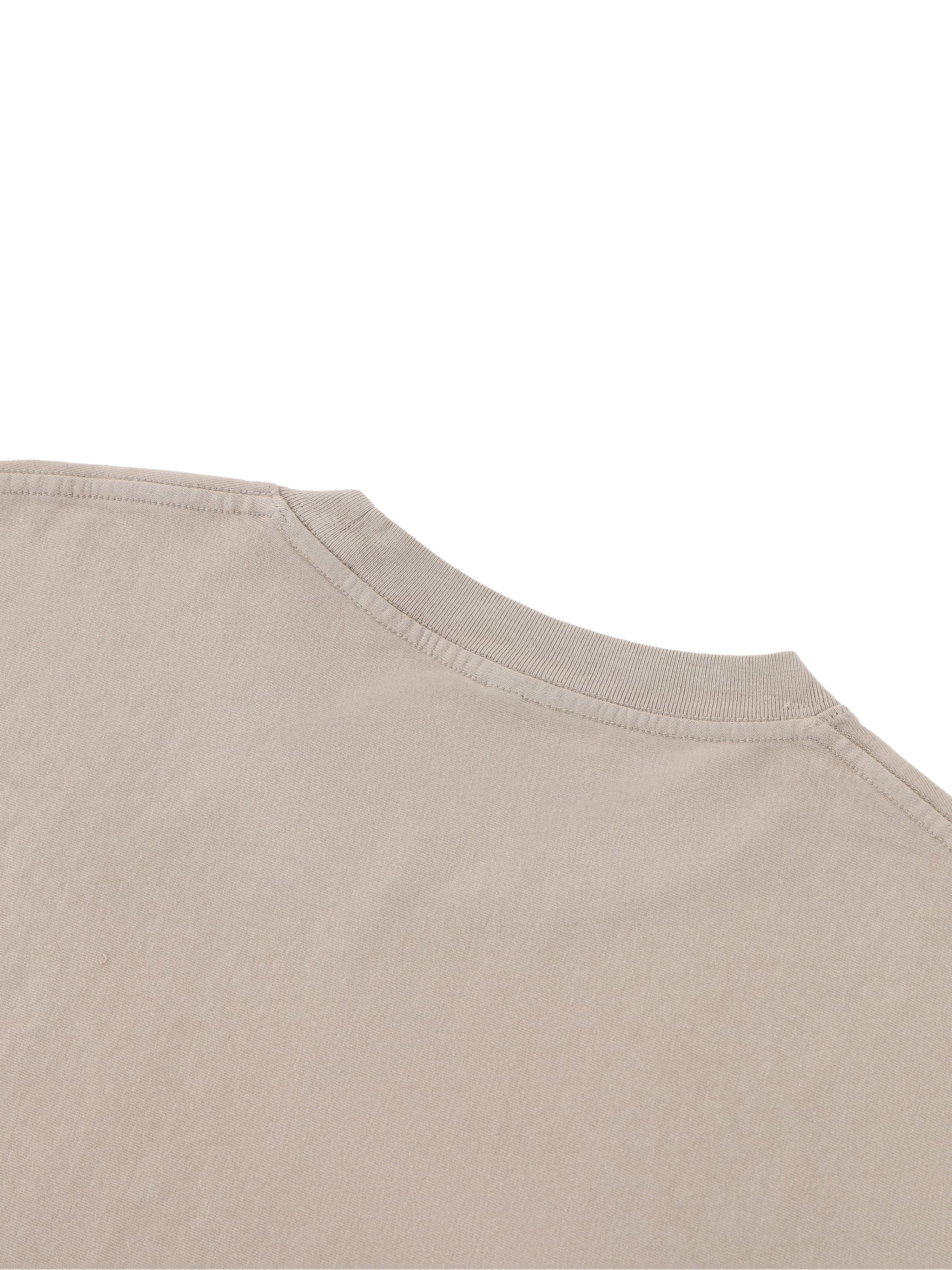 Close-up of beige heavyweight boxy T-shirt with ribbed collar and raw edge detail
