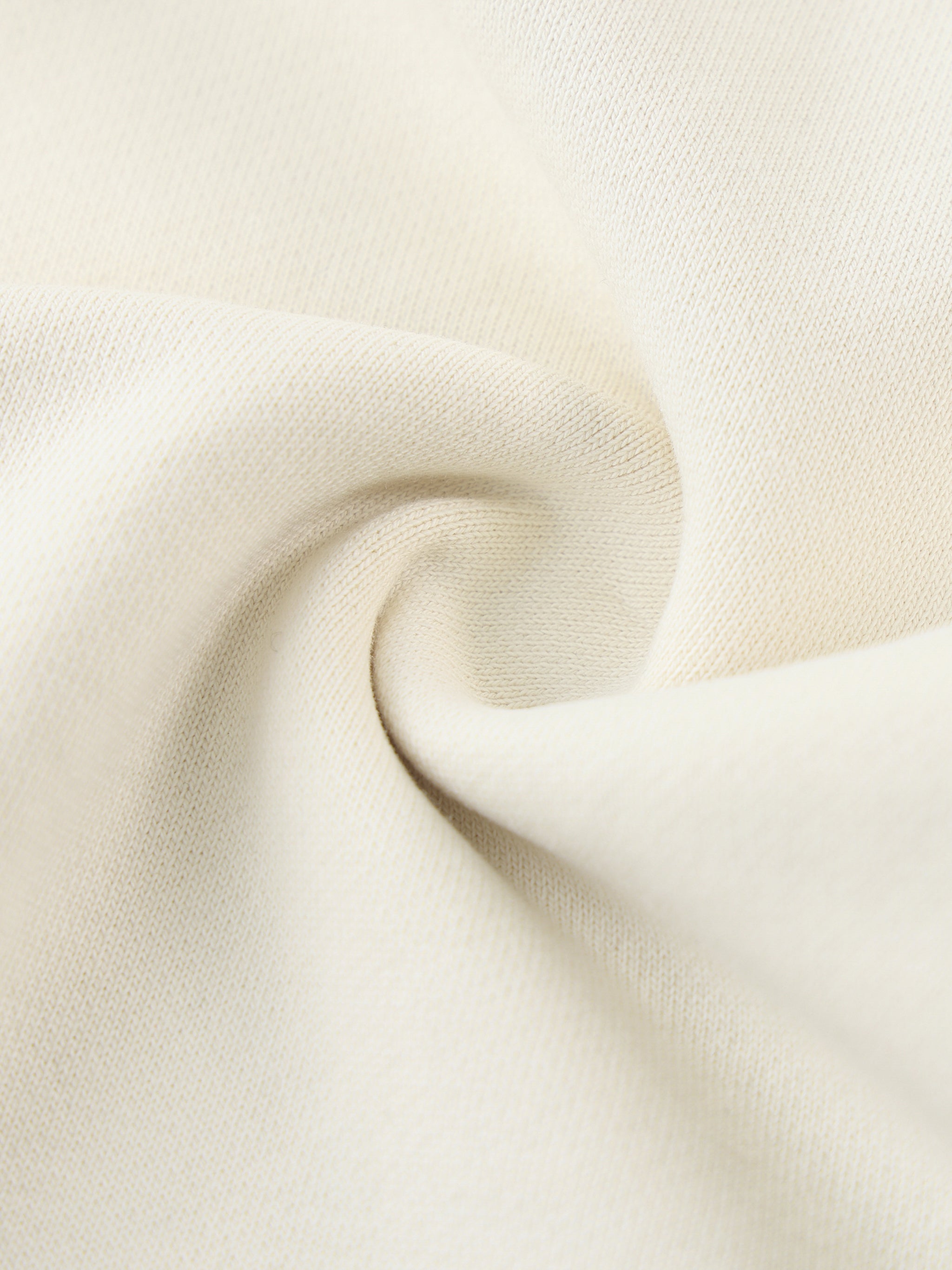 Close-up of heavyweight ivory cotton fabric with soft, textured weave detail