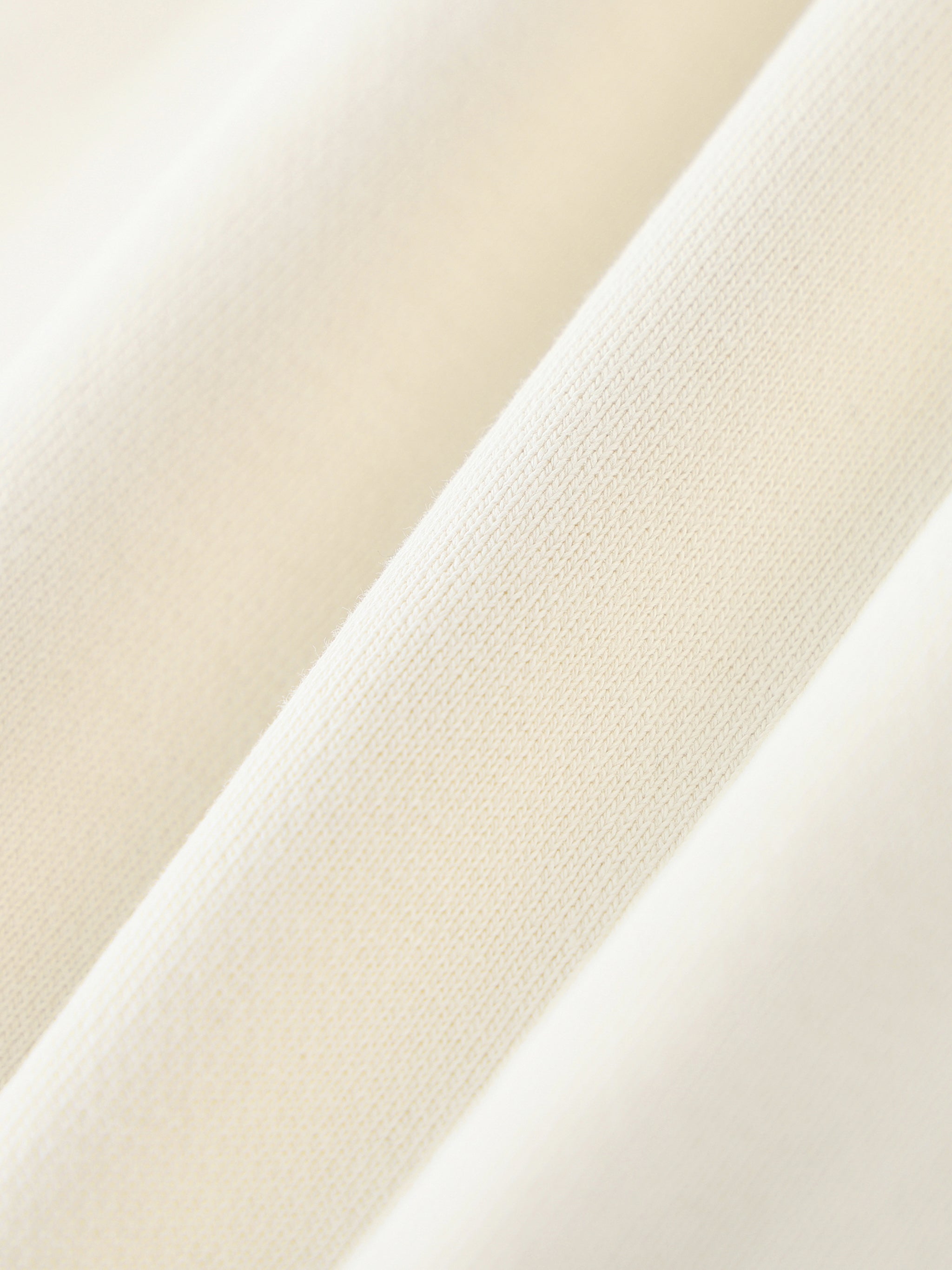 Close-up of heavyweight cream cotton sweatpant fabric texture