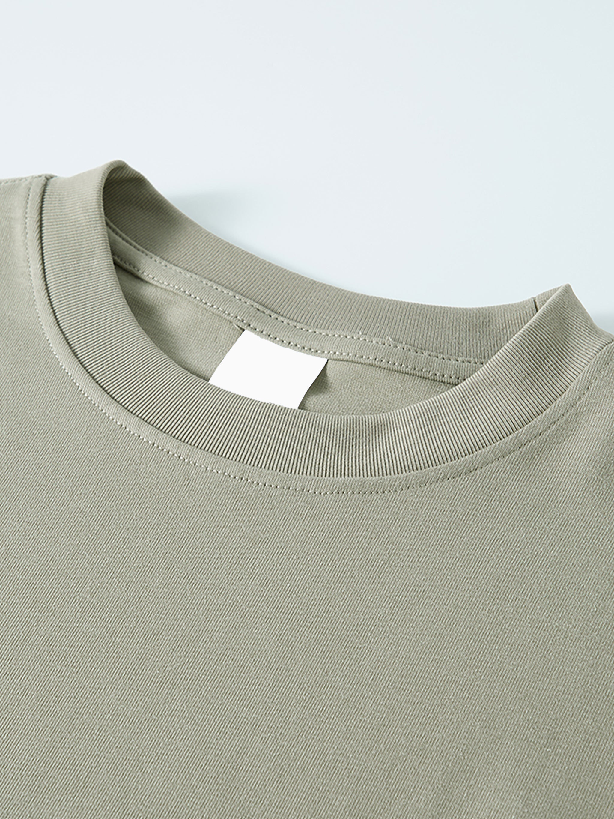 Close-up of heavyweight oversized unisex long sleeve t-shirt in light olive green