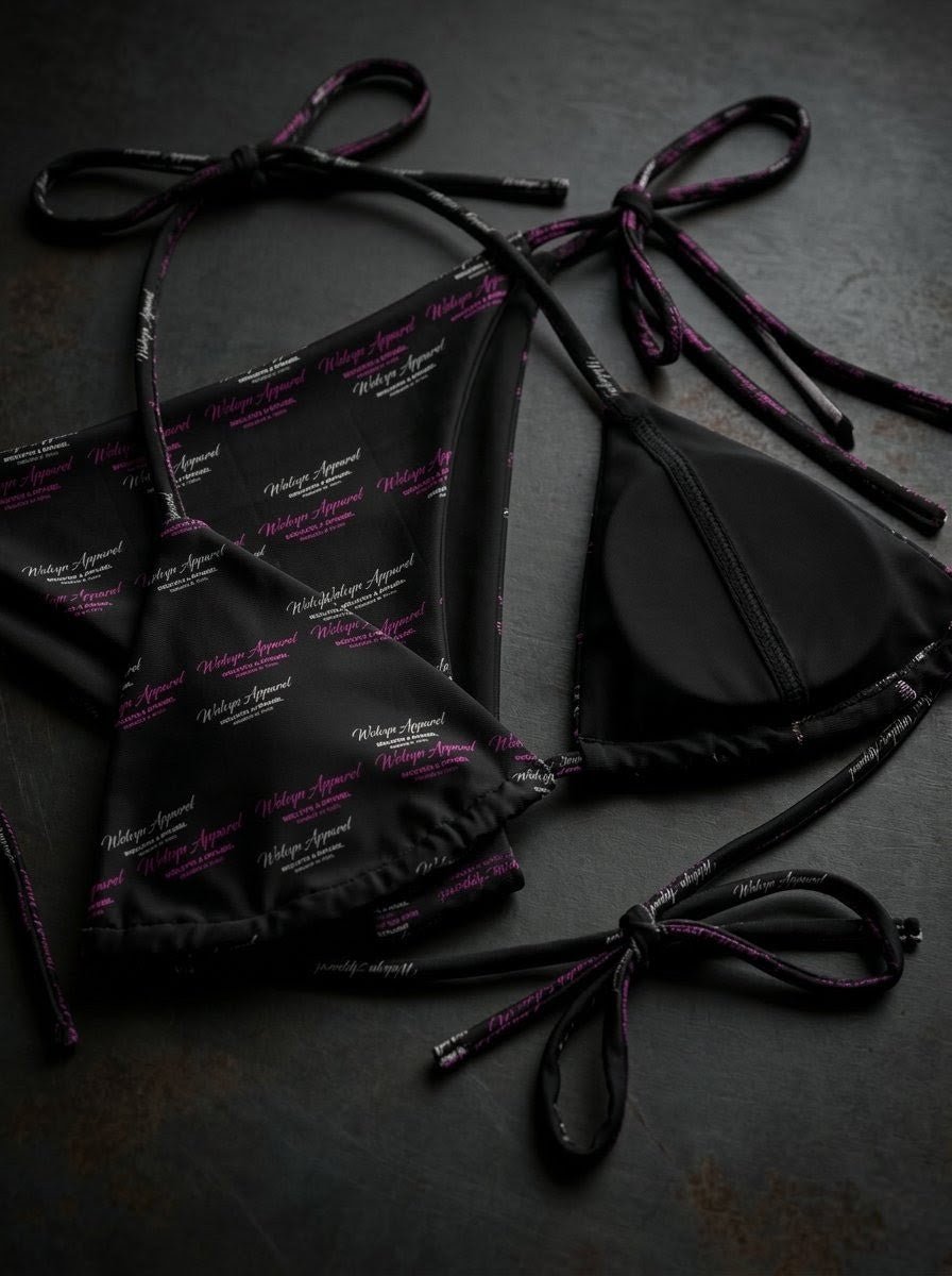 Black string bikini set with purple and white script font pattern on dark surface
