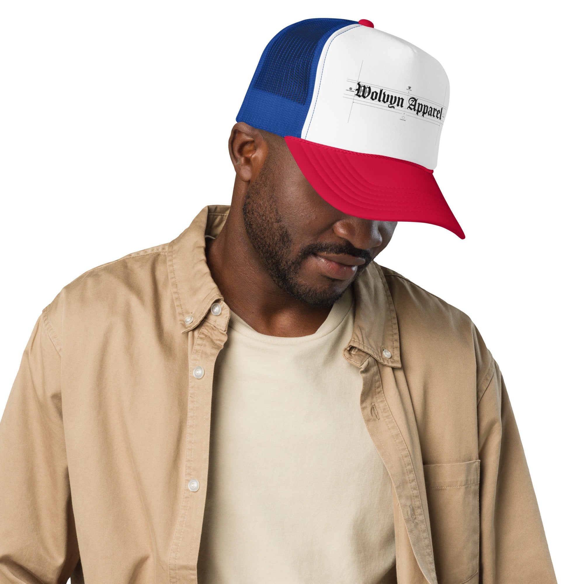 Man wearing a red, white, and blue foam trucker hat with black gothic text on the front.