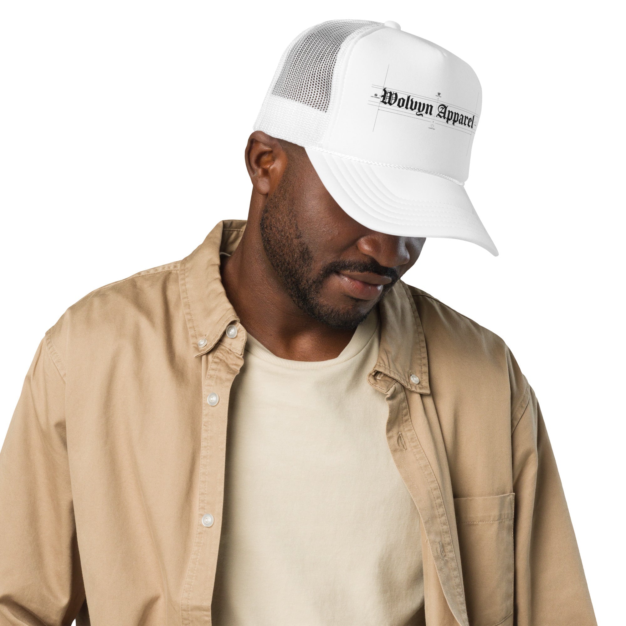Man wearing a white foam trucker hat with mesh back and gothic text logo on front