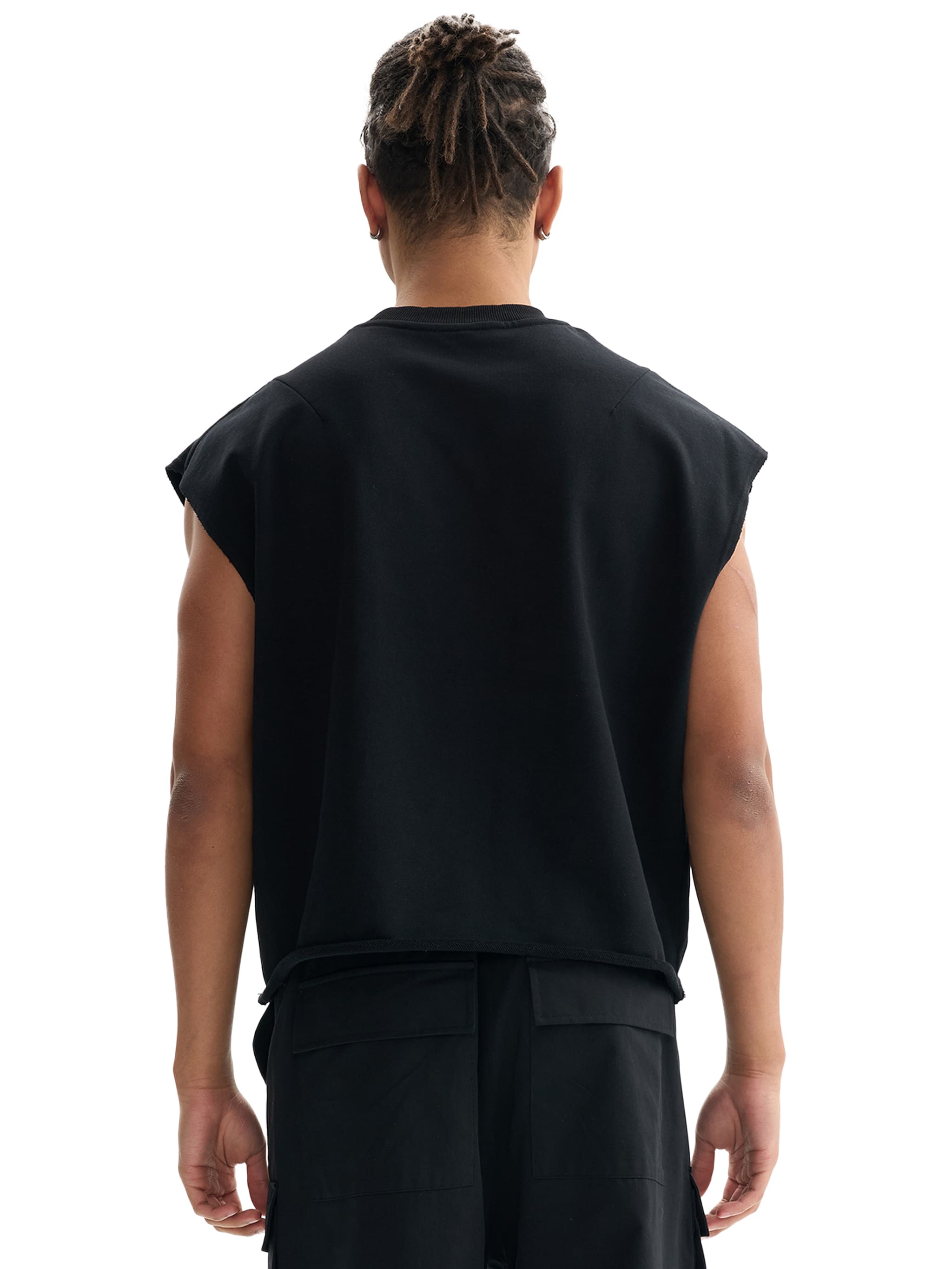 Back view of a person wearing a black French terry boxy tank top and black cargo shorts