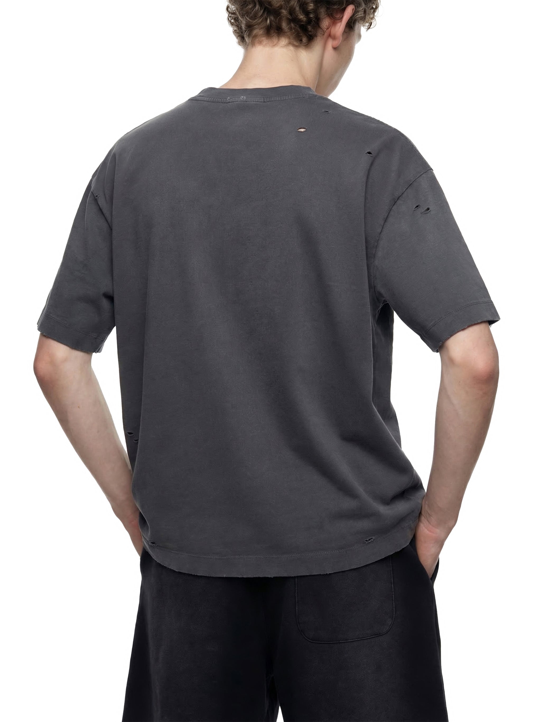 Back view of a black oversized distressed t-shirt with vintage wash and boxy fit