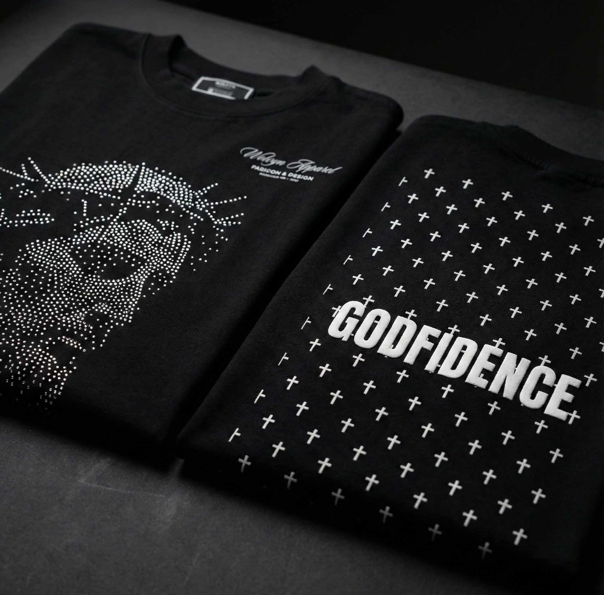 Black heavyweight cotton t-shirts with white cross details and bold GODFIDENCE text print
