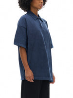Heavyweight snow washed navy blue polo t-shirt with short sleeves, worn by model