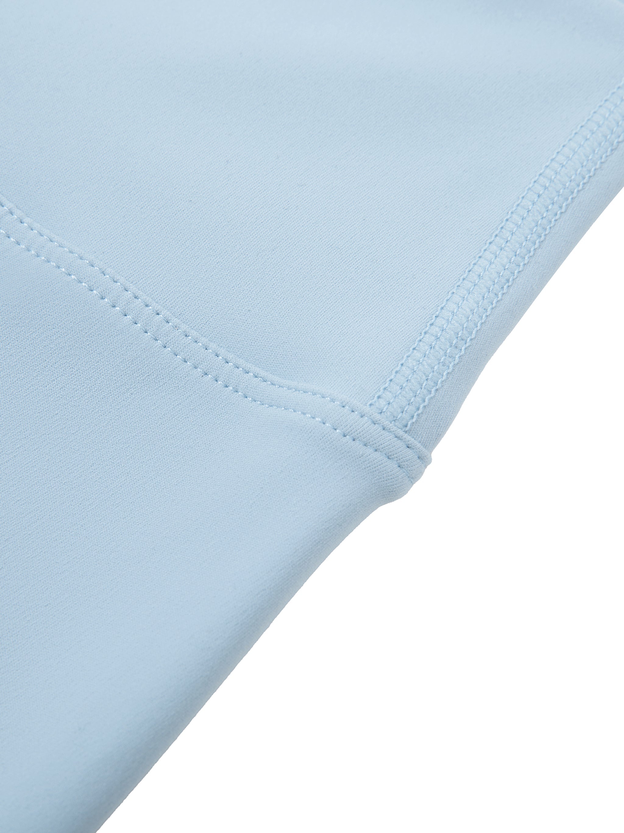 Close-up of light blue high-waisted biker shorts fabric and stitching detail