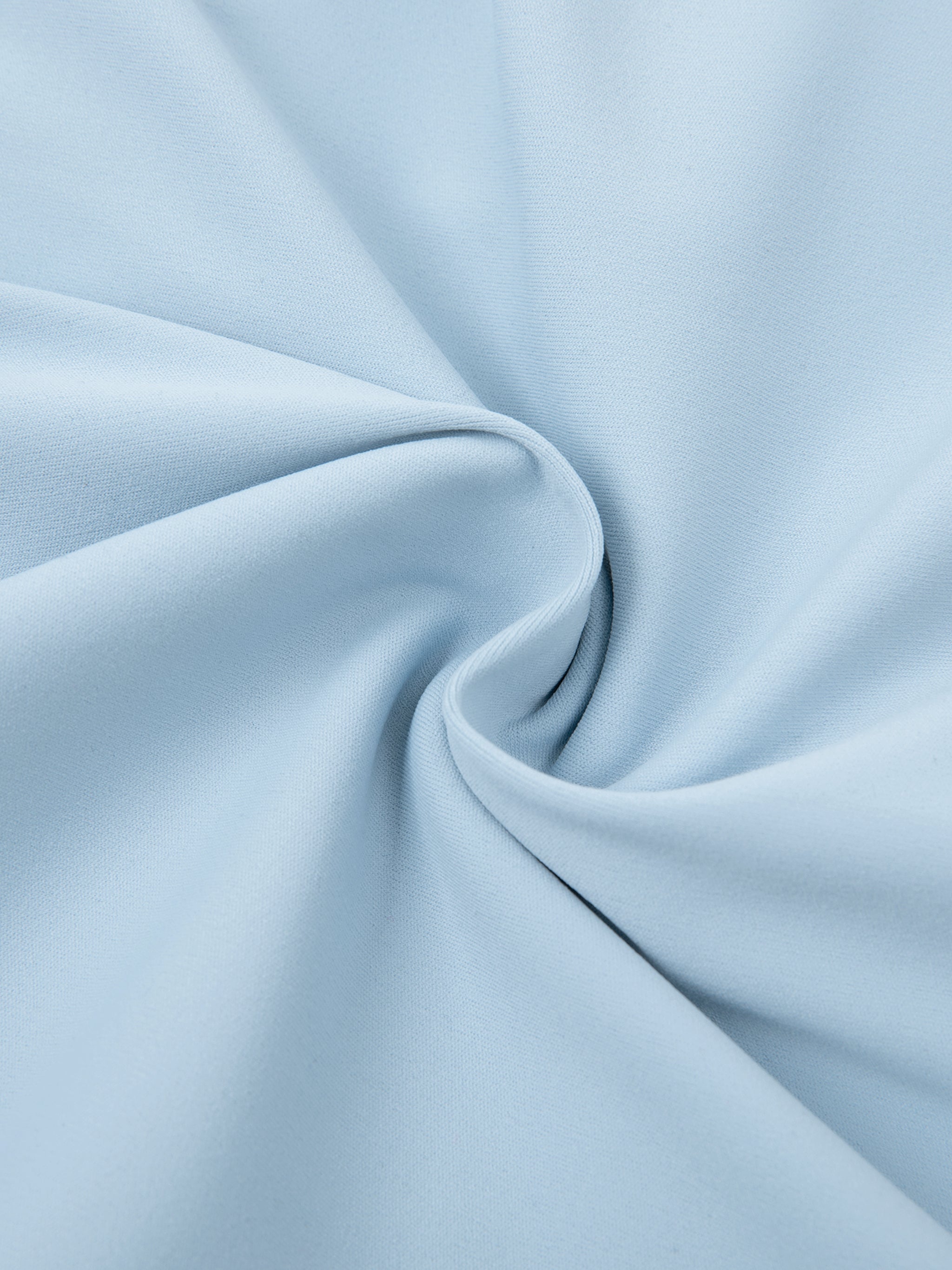Close-up of light blue high-waisted biker shorts fabric with smooth, stretchy texture.